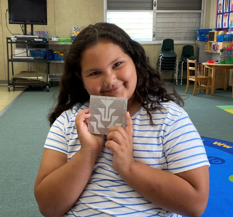 Student Holding their etching project